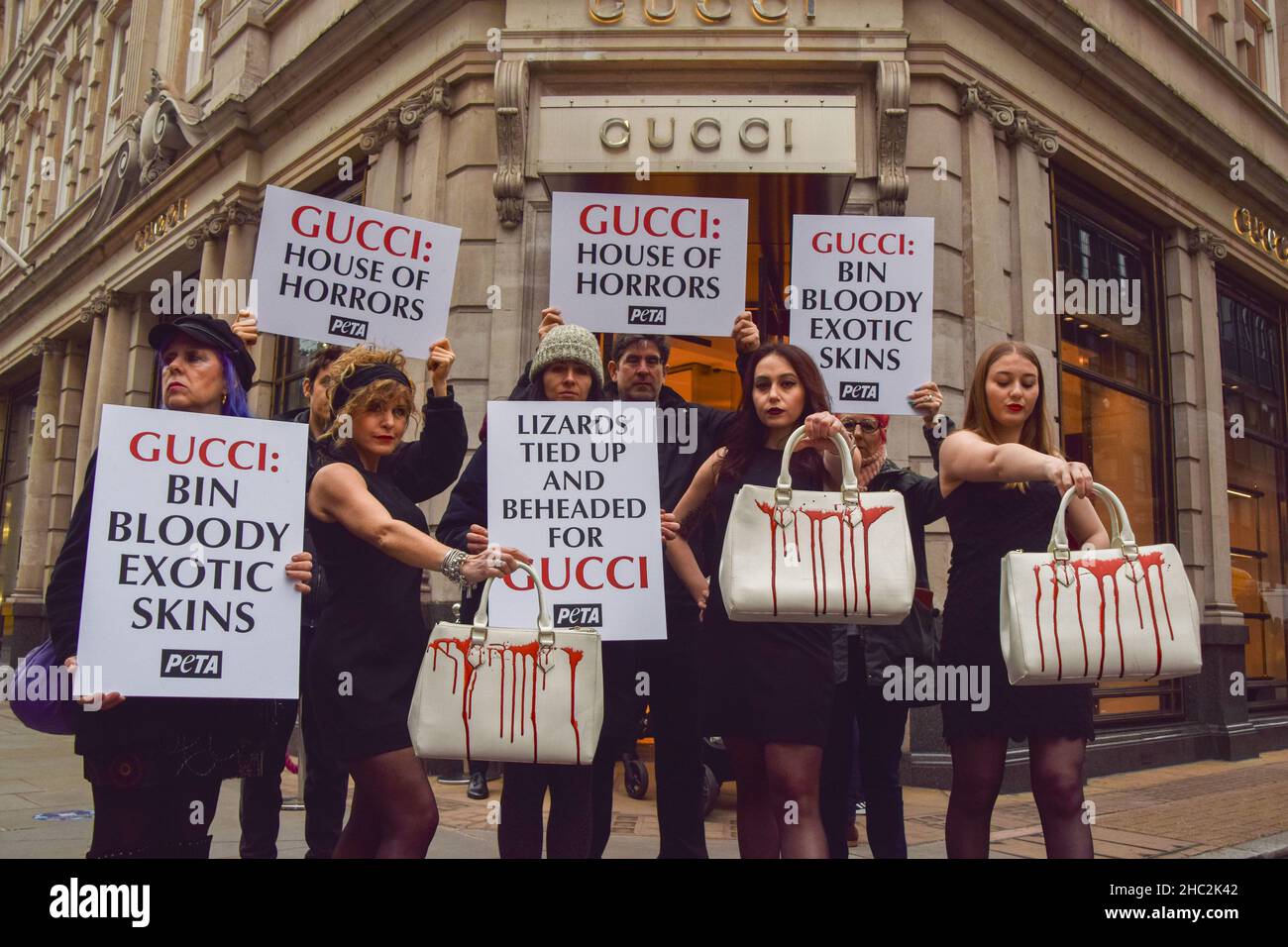 Activists hold handbags splashed with fake blood and placards demanding  that Gucci stops using exotic skins, during the protest.PETA (People for  the Ethical Treatment of Animals) activists gathered outside the Gucci store