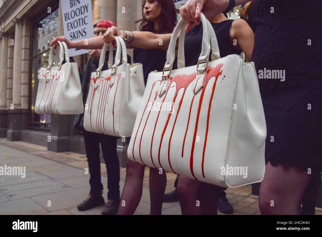 Activists hold handbags splashed with fake blood during the protest.PETA  (People for the Ethical Treatment of Animals) activists gathered outside  the Gucci store on Bond Street and staged a 'catwalk' with handbags