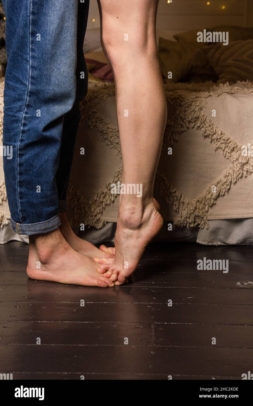 Closeup of male and female legs during a date Stock Photo