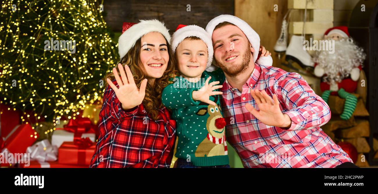 Capturing a happy moment. Happy family celebrate new year. Portrait loving  family. lot of xmas present boxes. merry christmas. Father and mother love  kids. small children and parents in santa hat Stock