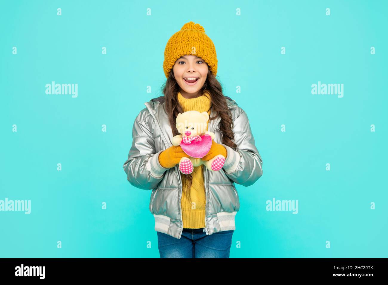 love toy for valentines day. amazed kid in puffer jacket and hat. childhood. Stock Photo