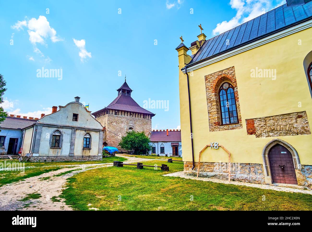 The pleasant walk around courtyard of Medzhybizh Castle among medieval buildings of different purposes, Ukraine Stock Photo