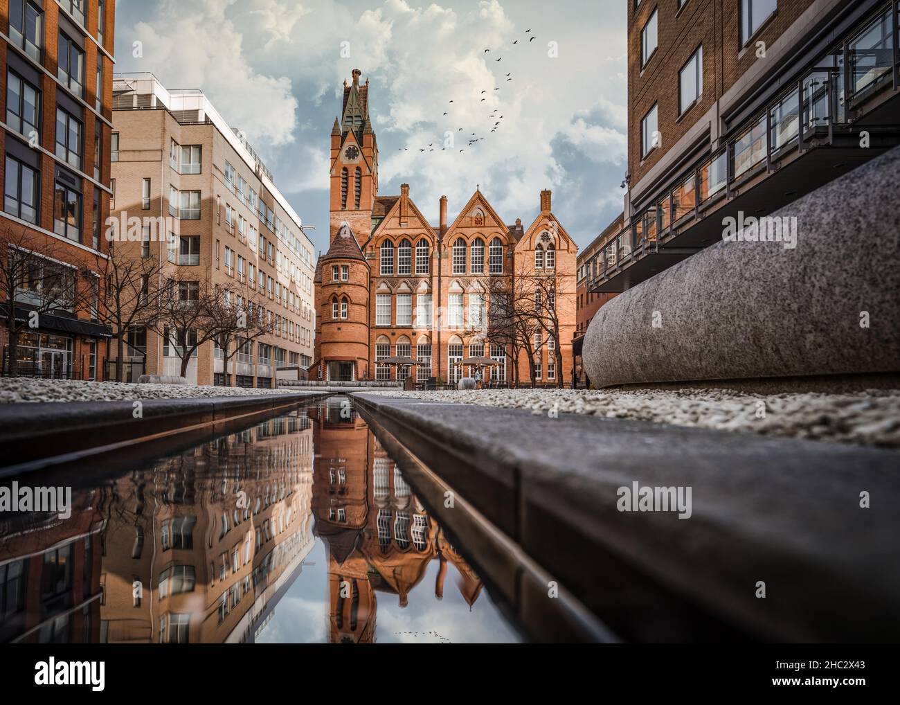 Brindley Place red brick church building reflected in water. West Midlands landmark buildings redevelopment in historic city centre reflection street Stock Photo