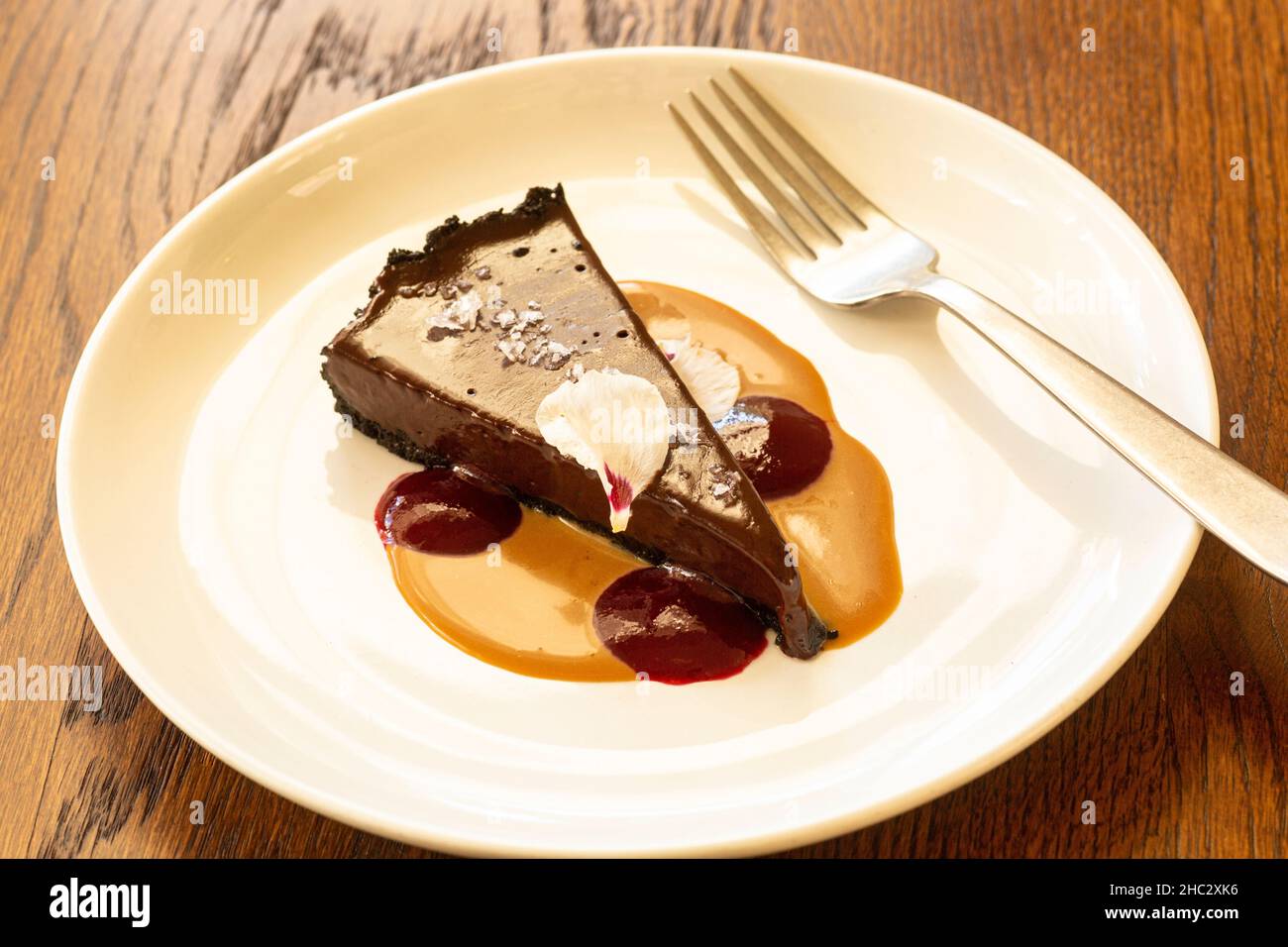 Mexican salted chocolate tart with dulce de leche raspberry sauce Stock Photo