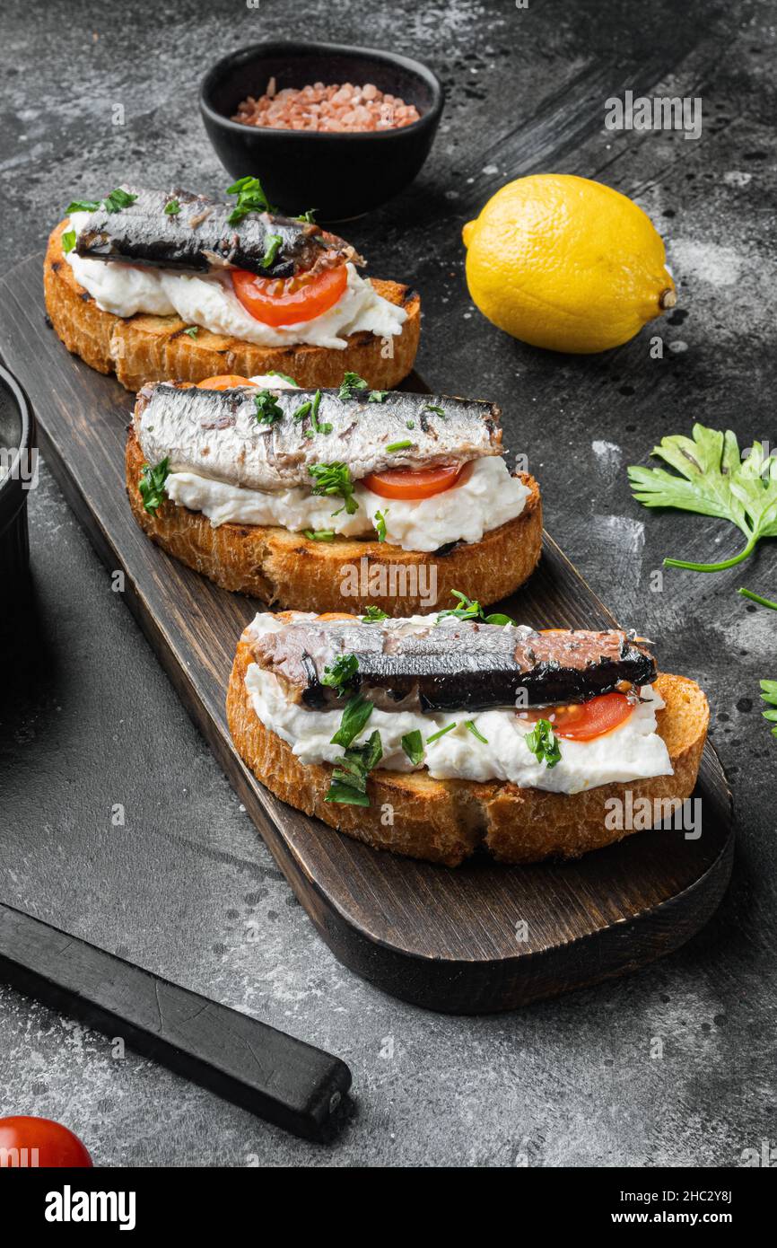 Sandwich with smoked fish set, on black dark stone table background ...