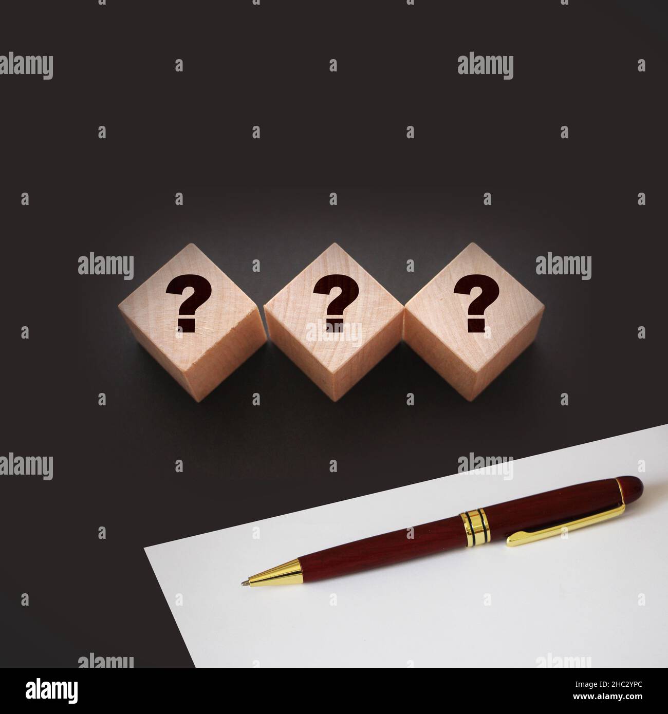 Three wooden blocks with black question marks. Faq questions and ...