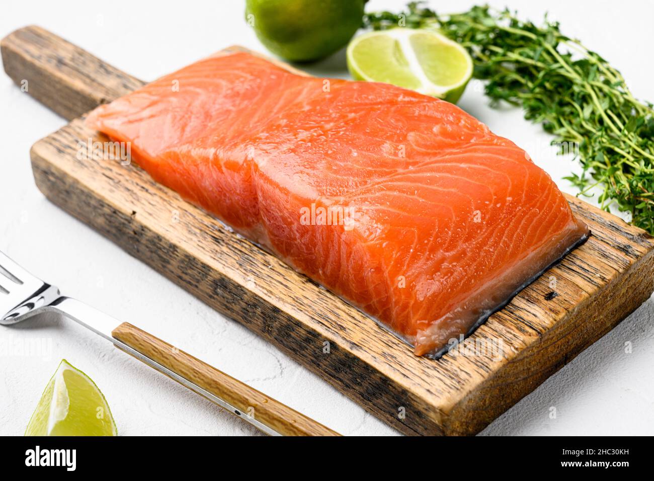 Salmon. Fresh raw salmon fish fillet set, with herbs, on white stone