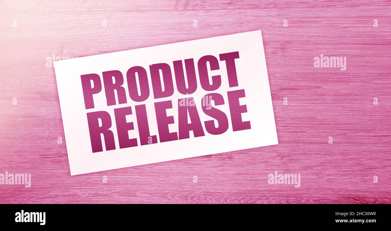 NEW RELEASE text on card on wooden background. business concept Stock ...