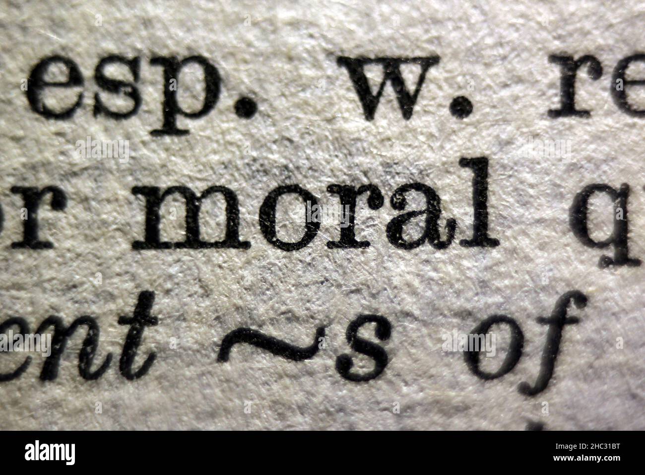 Word 'moral' printed on dictionary page, macro close-up Stock Photo