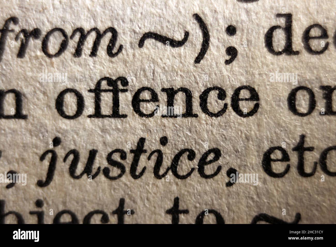 Word 'offence' printed on book page, macro close-up Stock Photo