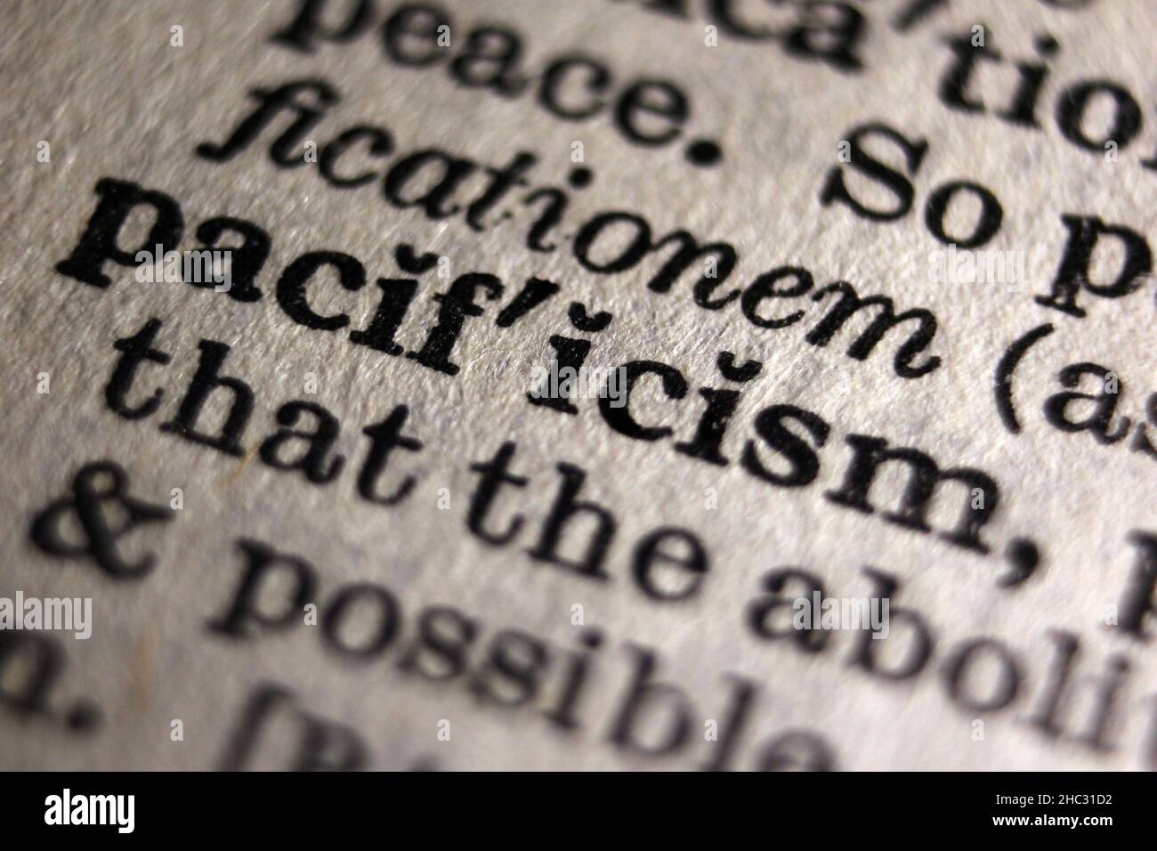 Word 'pacificism' printed on book page, macro close-up Stock Photo