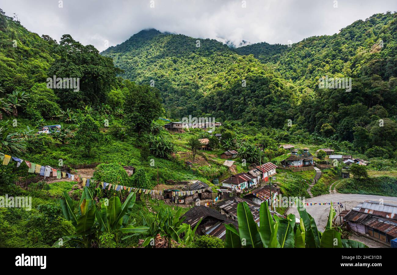 A small village surround by Himalaya foothills and forested slopes on near Indian highway 229  between Bhalukpong and Tawang, Arunachal Pradesh, India. Stock Photo