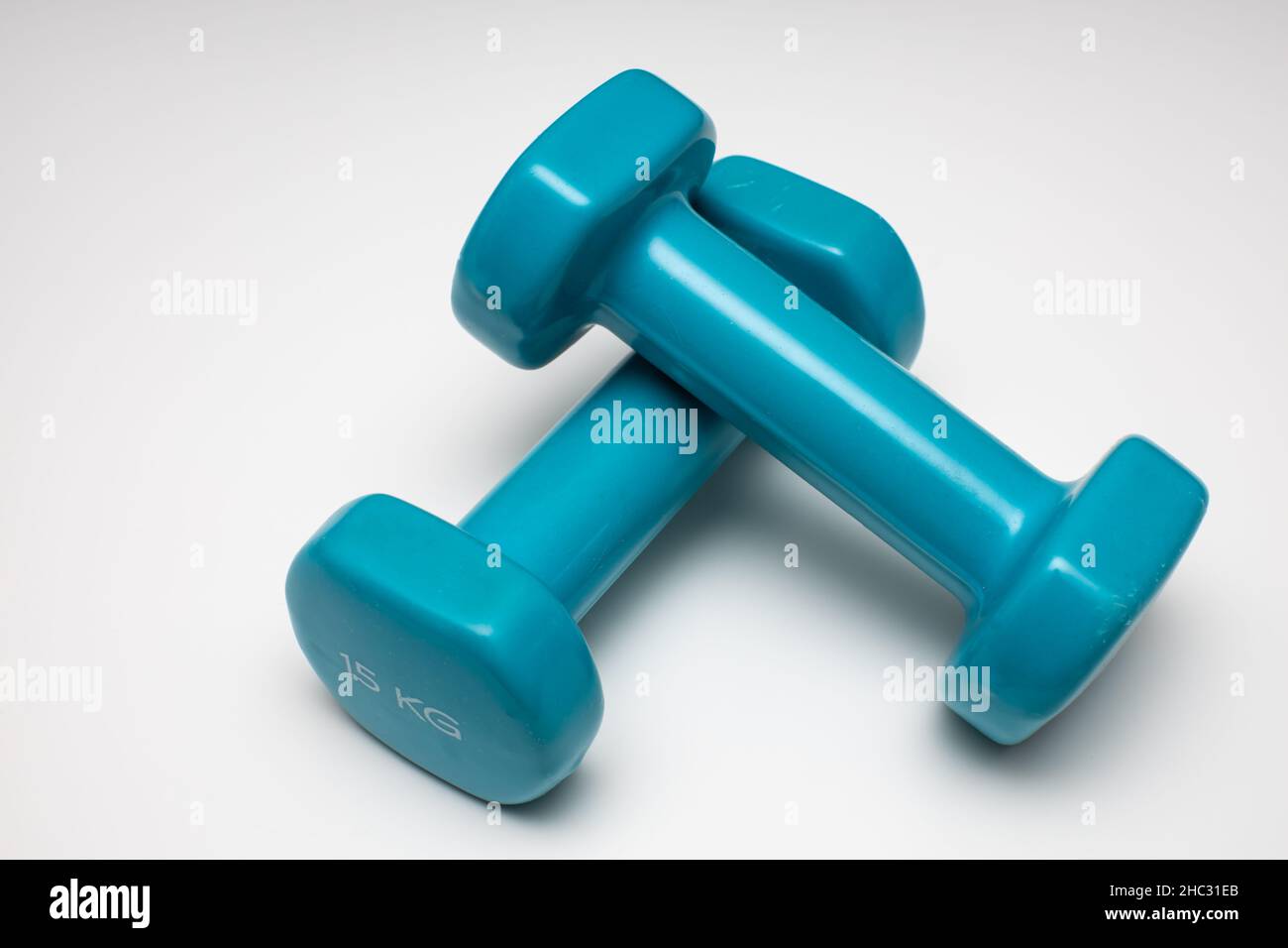 https://c8.alamy.com/comp/2HC31EB/two-small-and-light-dumbbells-lie-on-a-white-background-high-quality-photo-2HC31EB.jpg