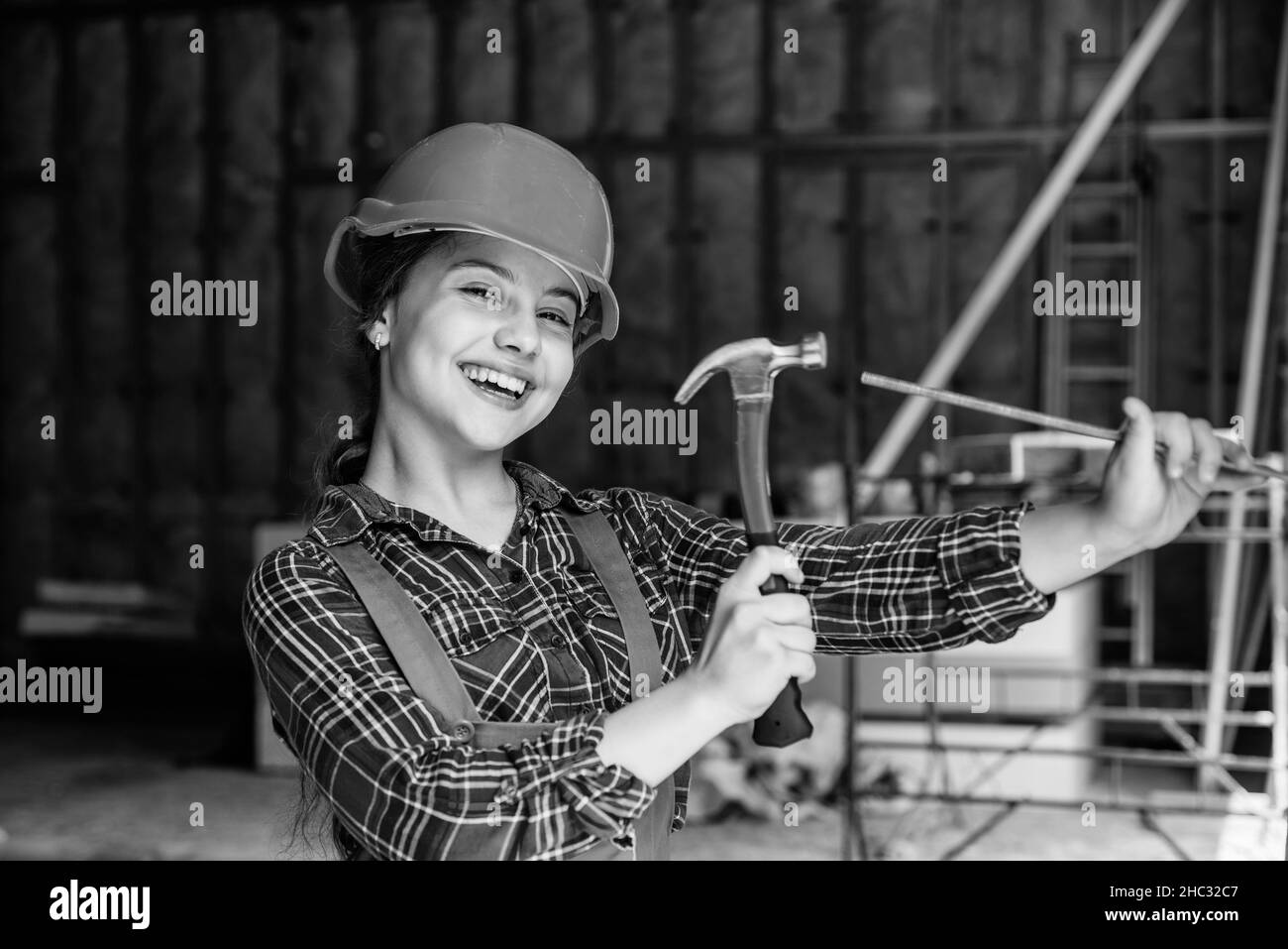 engineering education. future engineer. happy kid use hammer repairing