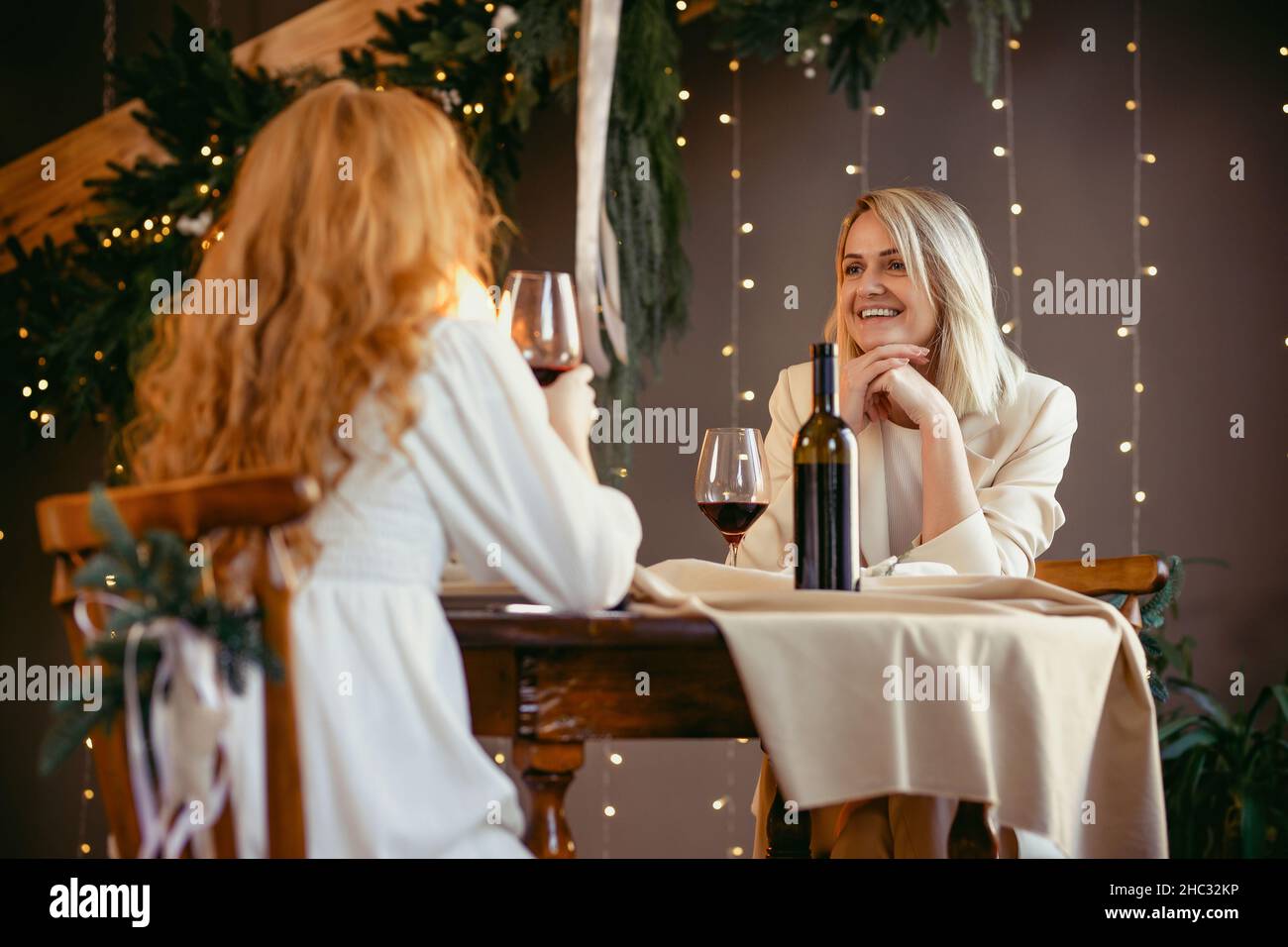 lesbian couple having dinner in a restaurant Girl giving a gift to her sweetheart Stock Photo