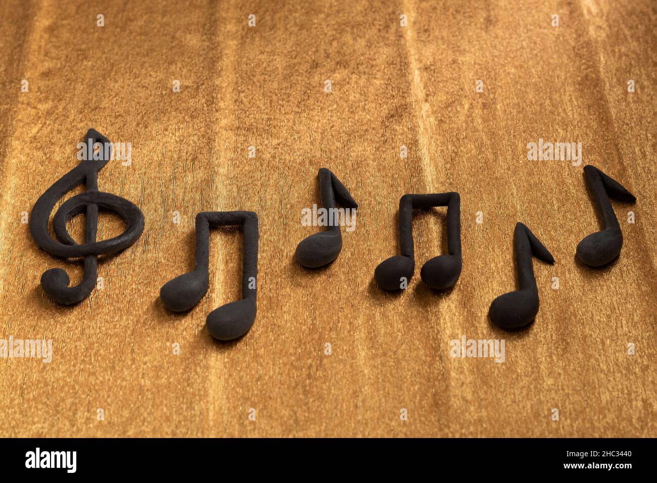 Black treble clef and music notes on golden background. Violin key. Key