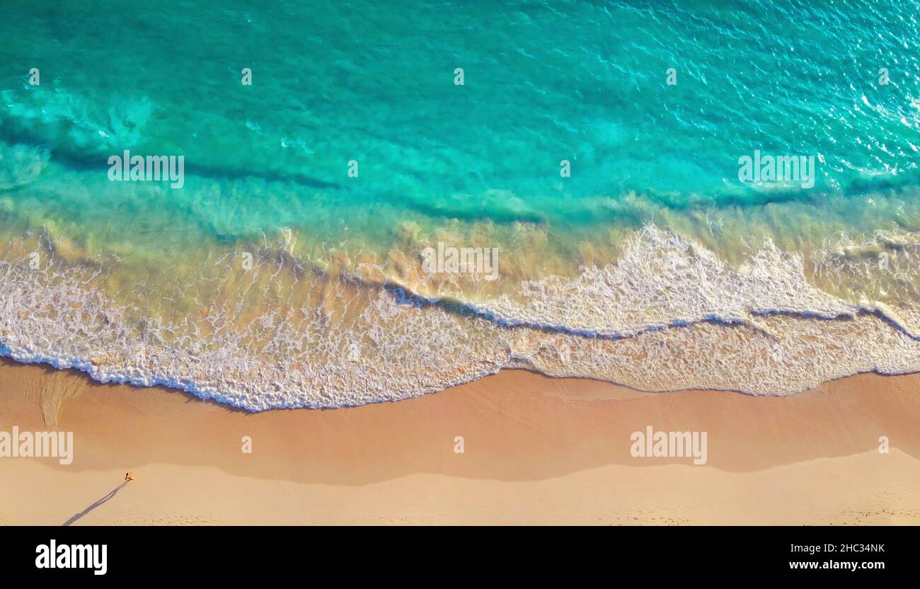 Aerial view top view tropical sea beach with white sand. Top view empty and clean beach. Aerial view of a transparent blue sea and sand beach at sunny day in summer. Summer seascape from aerial view Stock Photo