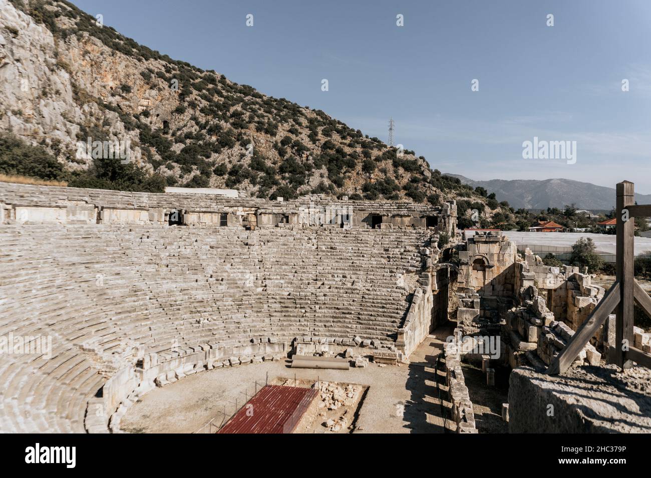 Ancient Greek theatre in Myra, Turkey. Amphitheater with the rock-cut tombs of the Lycian necropolis Stock Photo