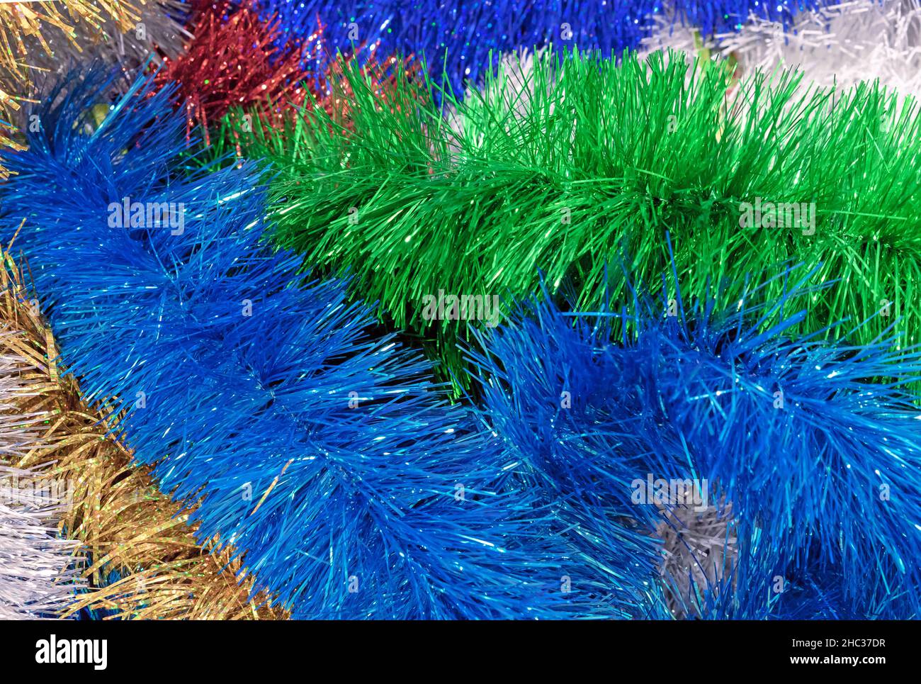 Multicolored Christmas tinsel. Tinsel for Christmas decor. Stock Photo