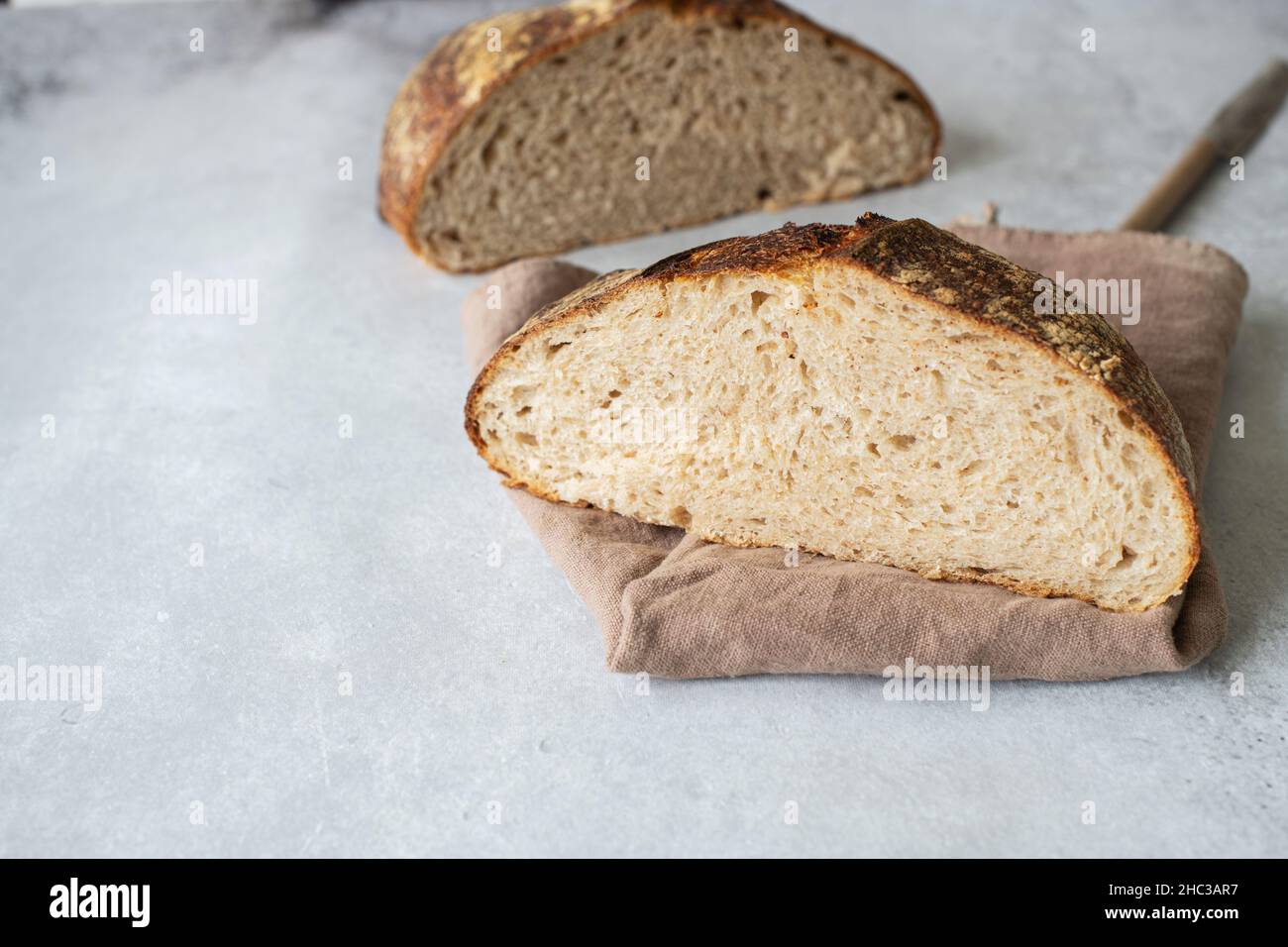 Homemade artisanal sourdough bread. Healthy home baking concept. Stock Photo