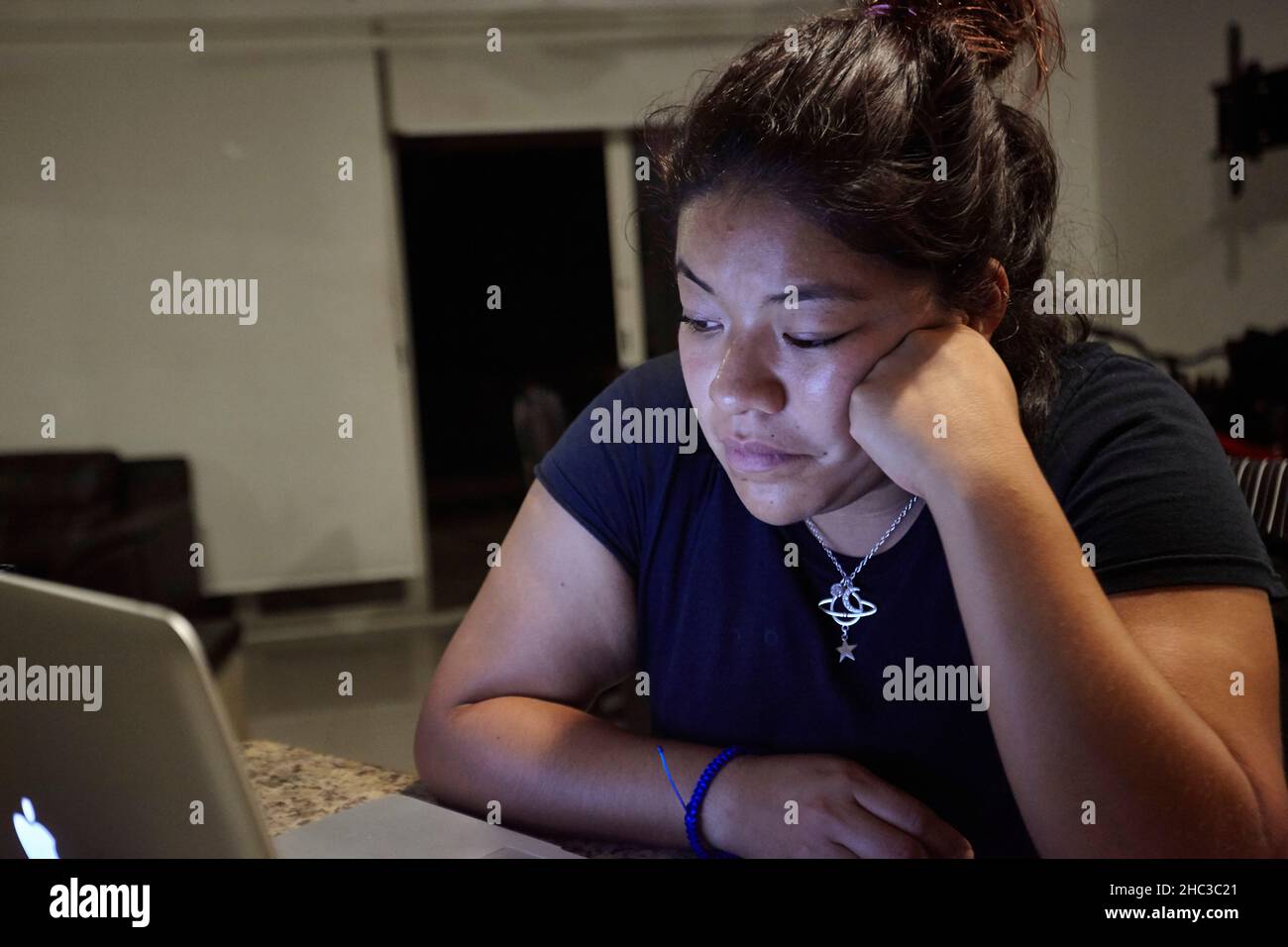 Young Mexican girl studyes and uses her laptop Stock Photo