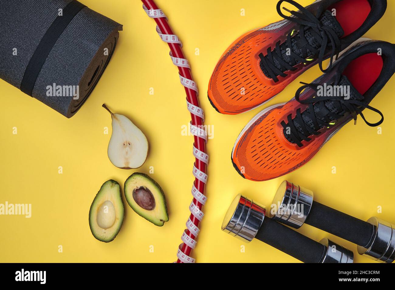 Orange sports sneakers, gymnastic ring wrapped in a measuring tape with a meter Stock Photo Alamy
