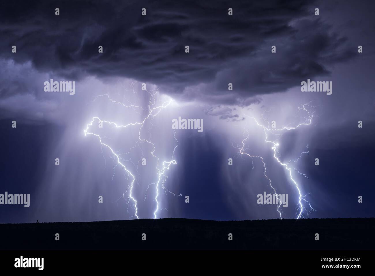 Lightning bolts in the night sky with a dramatic thunderstorm near Holbrook, Arizona Stock Photo