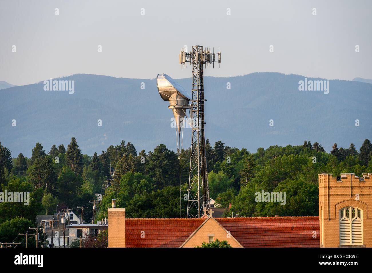 BOZEMAN, MONTANA, USA – JULY 17, 2021: Telecommunications site on a church in downtown Bozeman, wildfire smoke filled sky Stock Photo
