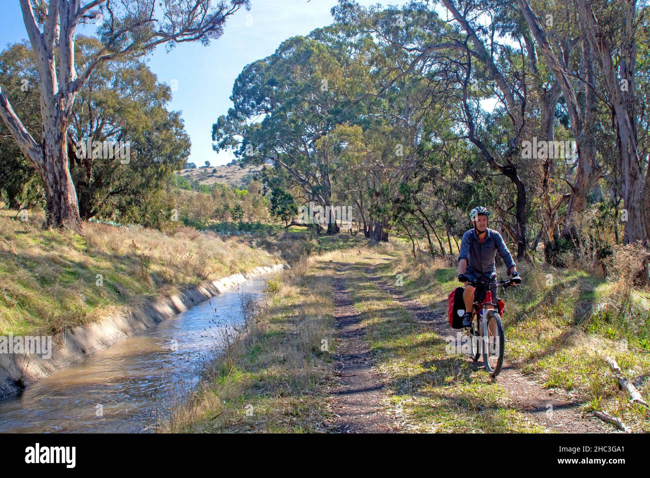 Cycling on the Goldfields Track beside the Coliban Water Channel Stock Photo