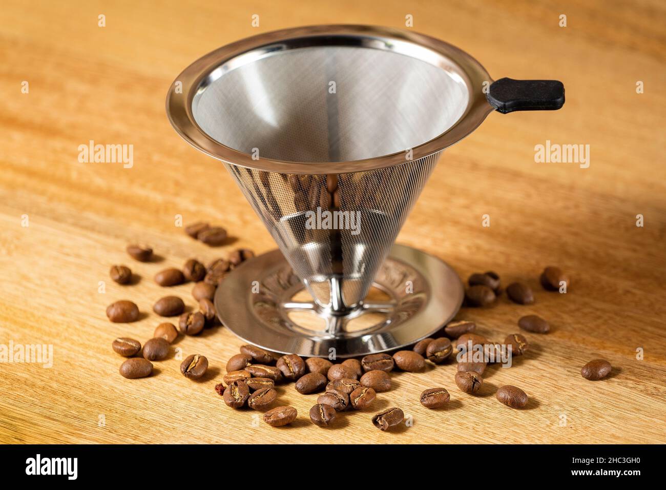 Slow drip coffee filter metal cone Wood Background Stock Photo Alamy