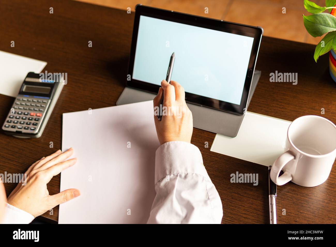 Woman using digital tablet with digital pencil, businesswoman or student. Working from home concept Stock Photo