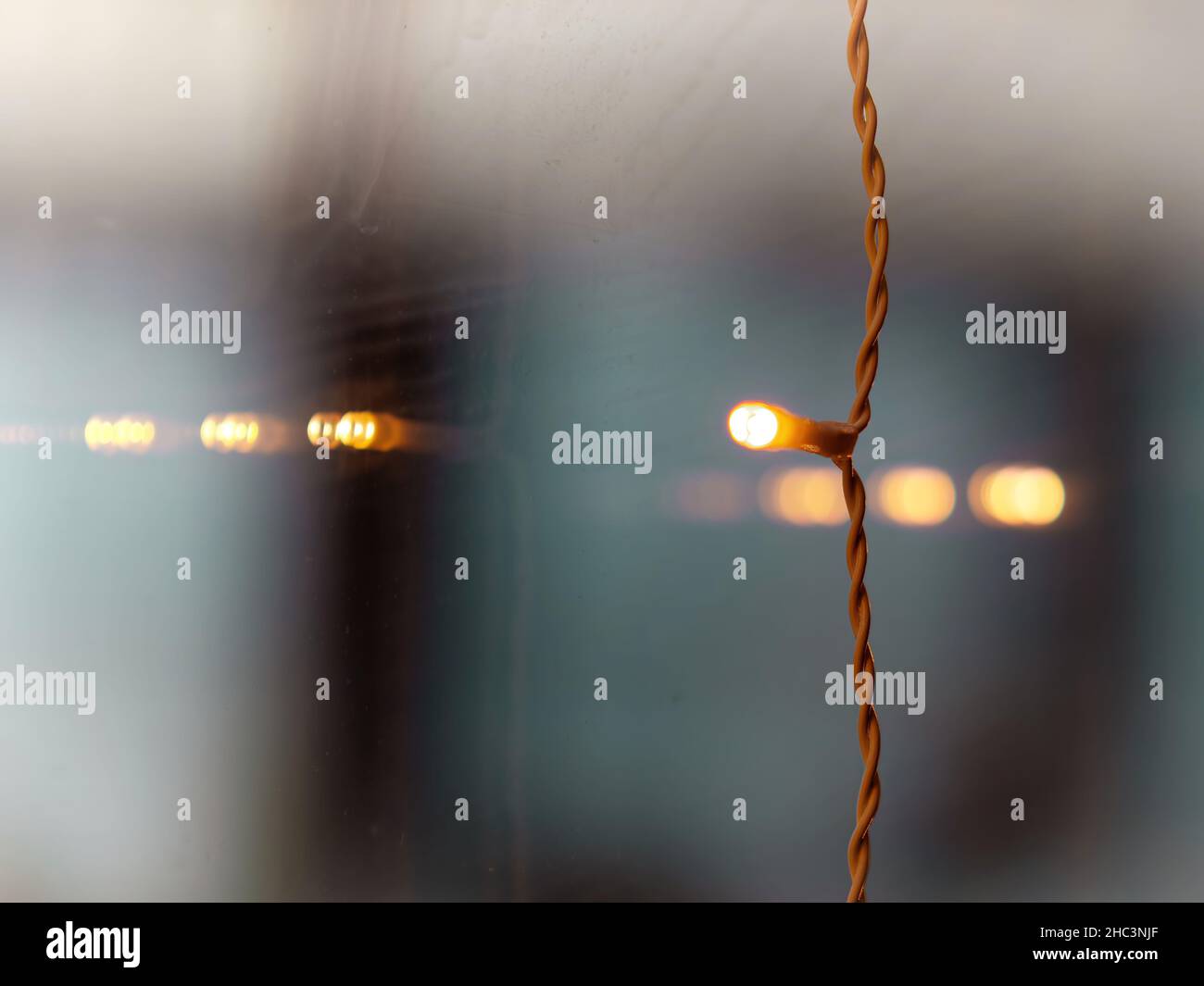 Selective focus photo of a small decoration led light hanging on a window Stock Photo