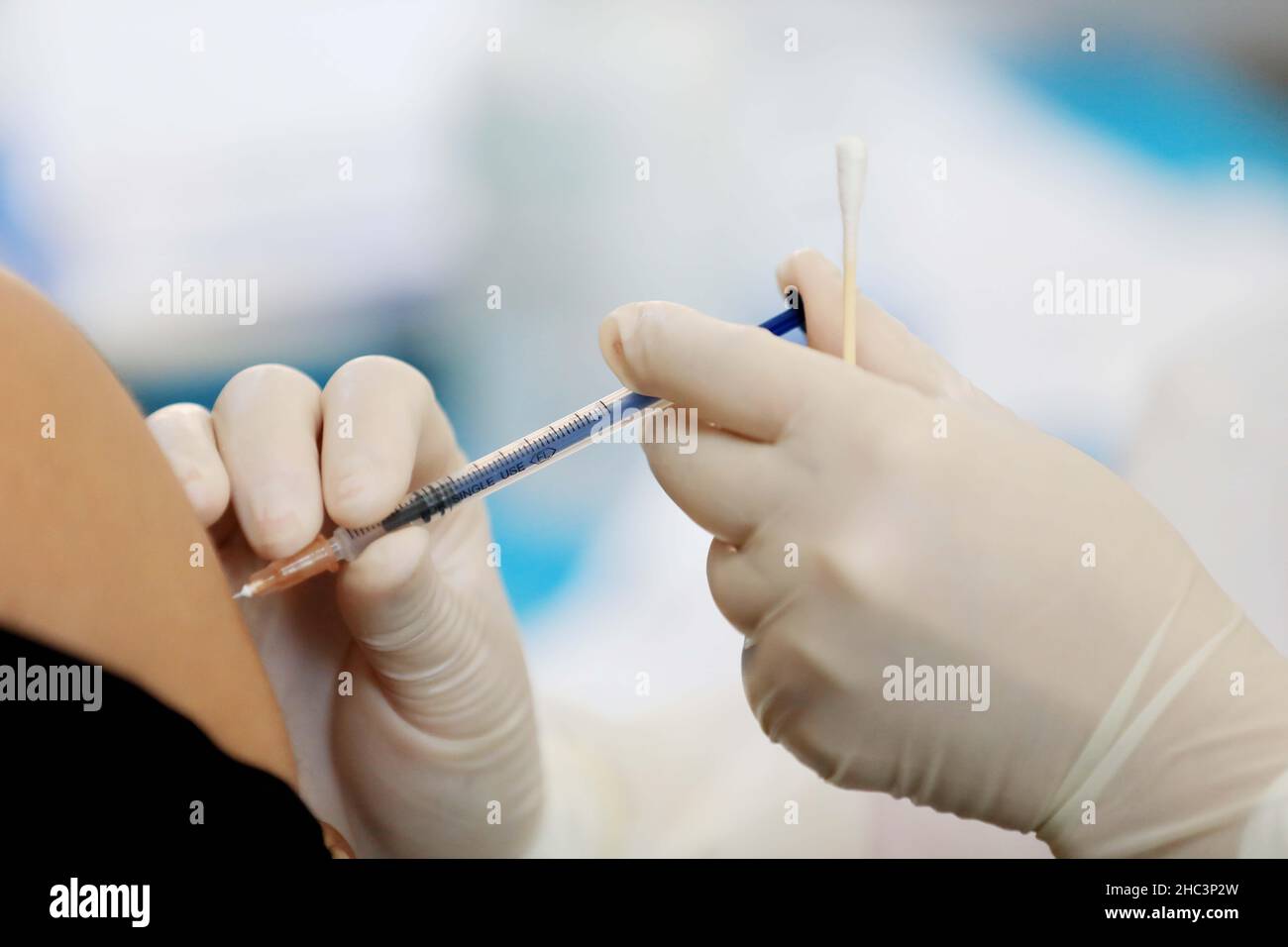 LIUZHOU, CHINA - DECEMBER 12, 2021 - Medical workers administer 'booster needle' at a centralized vaccination site for COVID-19 vaccine in Liuzhou, Gu Stock Photo