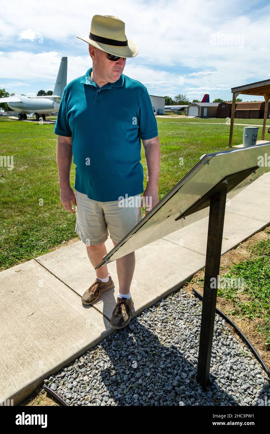 A visitor stops to read an informational plaque at the Grissom Air Museum in Bunker Hill, Indiana, USA. Stock Photo