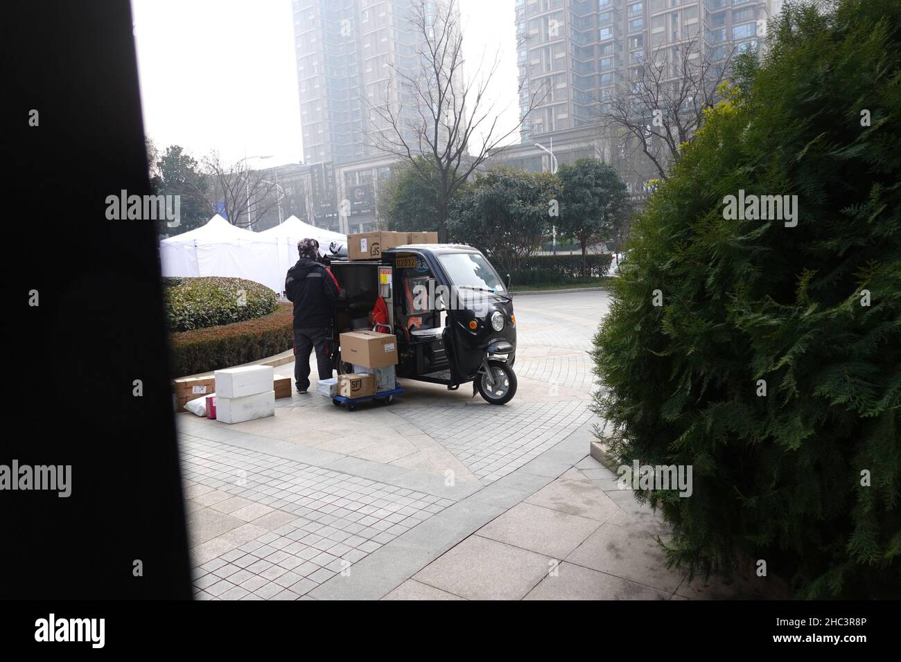 XI'AN, CHINA - DECEMBER 24, 2021 - An SF Express Courier calls residents at a gated residential area in Qujiang, Yanta District, Xi 'an city, Northwes Stock Photo