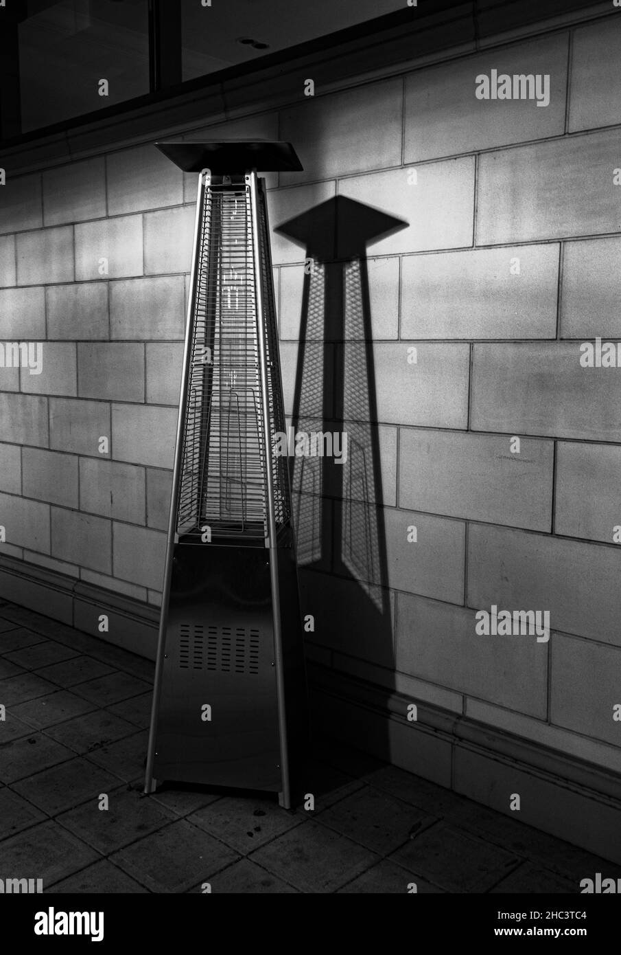 Vertical grayscale shot of the outdoor heater. Stock Photo