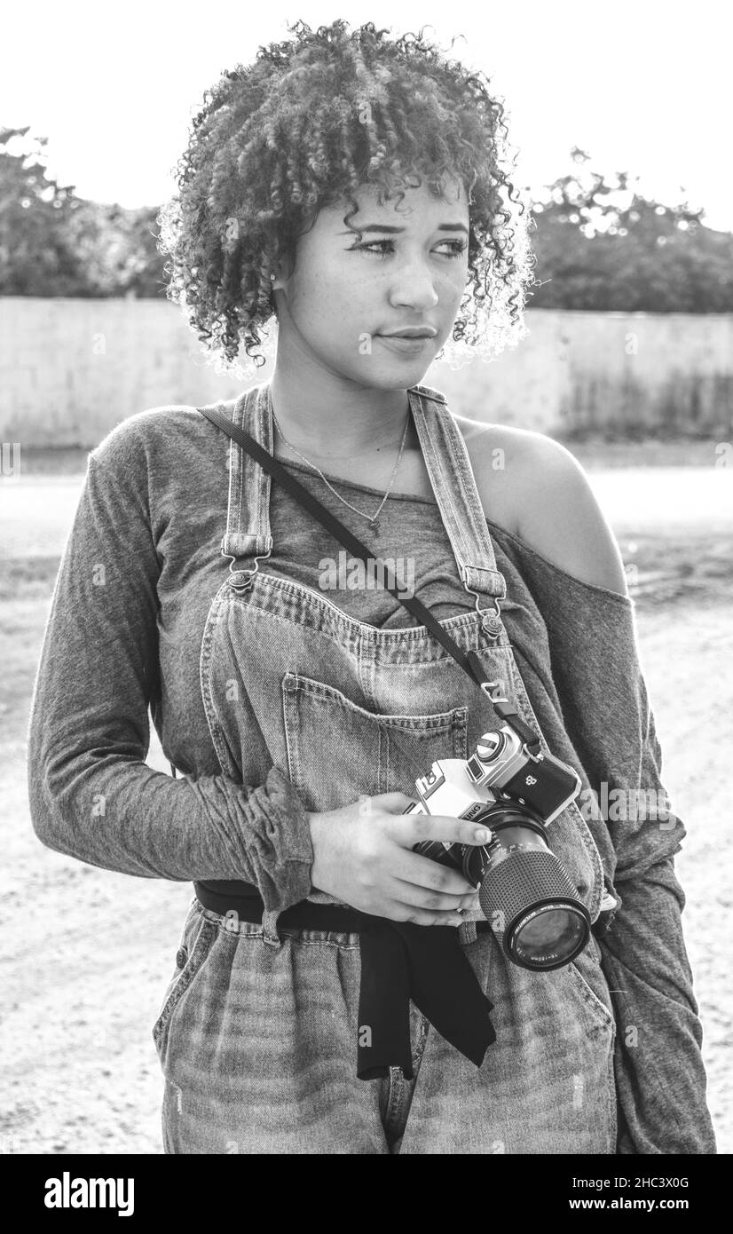 Girl who is dedicated to photography prepares from home to go to take photos of Stock Photo