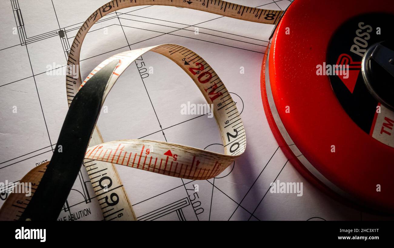 Closeup of measuring tape on architectural drawings Stock Photo - Alamy