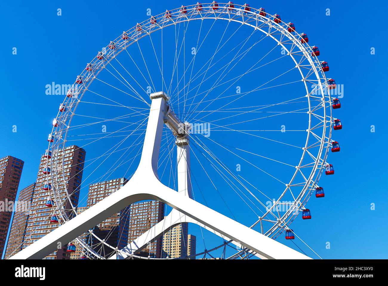 120 metre high Tianjin Eye viewed from Haihe River Tianjin. Opened in 2009, it rises above Yongle Bridge and Haihe River - connecting with Grand Canal Stock Photo