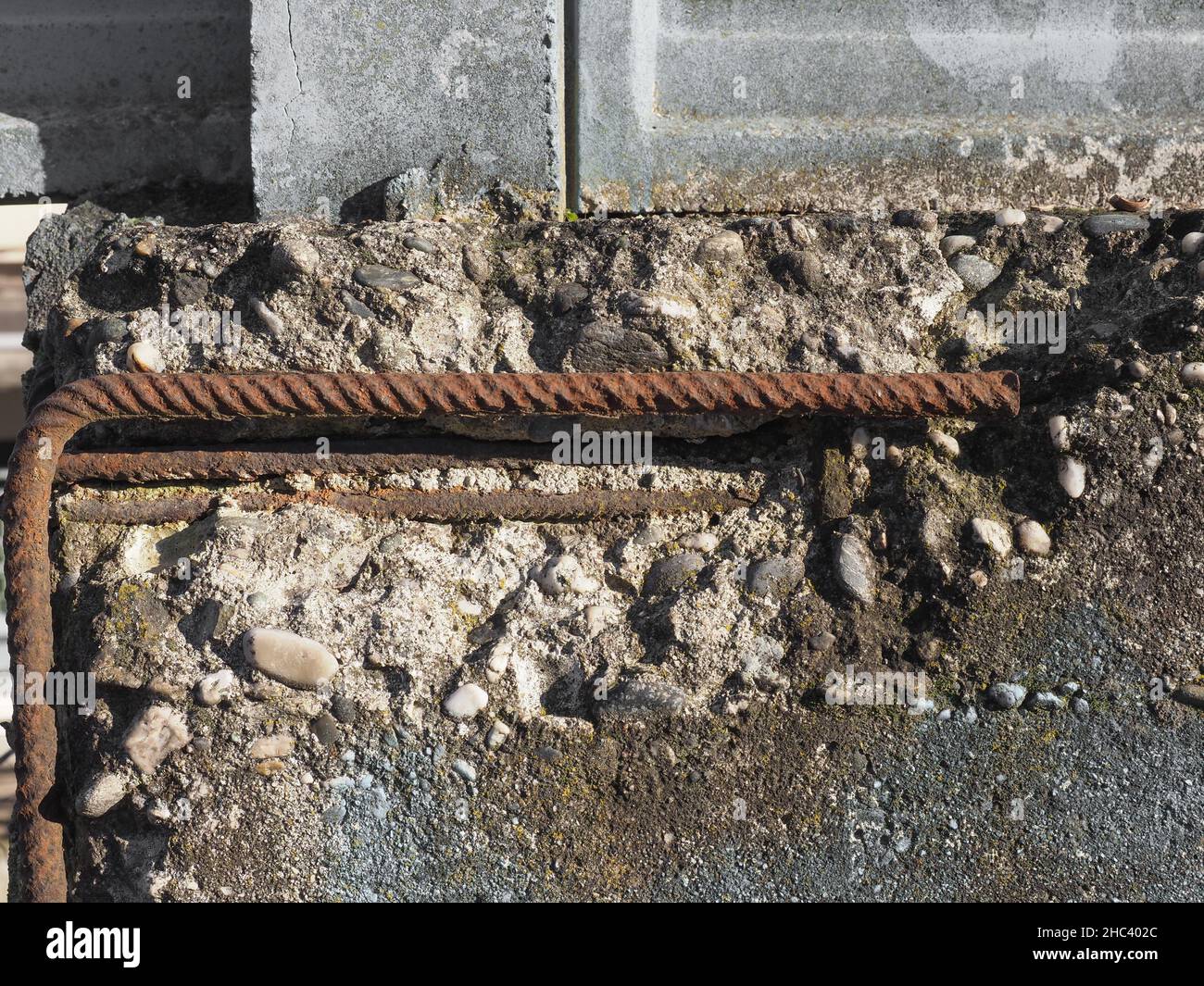damaged reinforced concrete with exposed rusted steel resistance bars