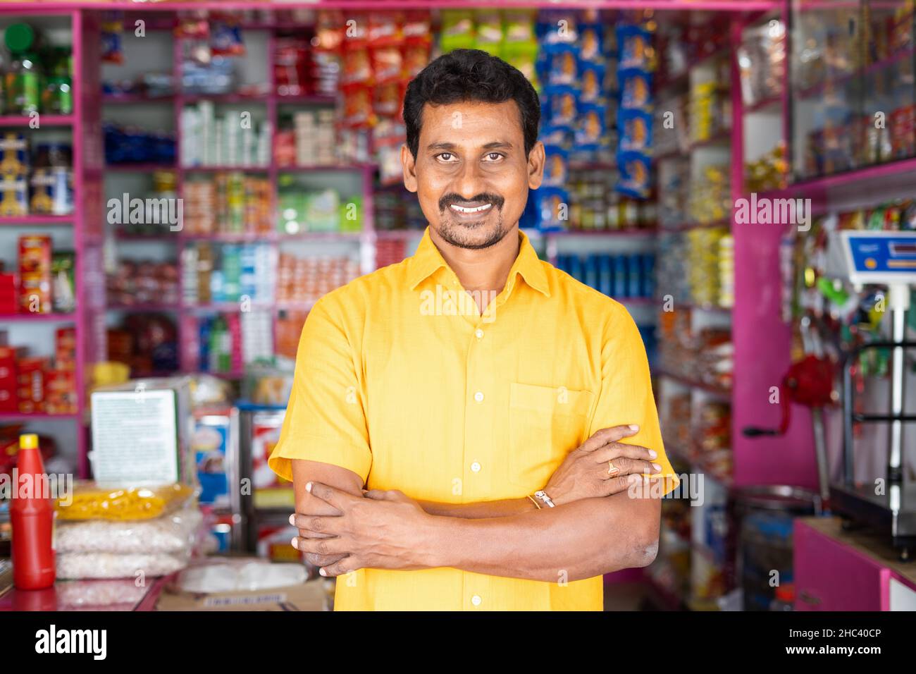 Portrait Of Successful Indian Kirana Or Groceries Businessman Standing Confidently With Smile By Looking At Camera Concept Of Small Business 2HC40CP 