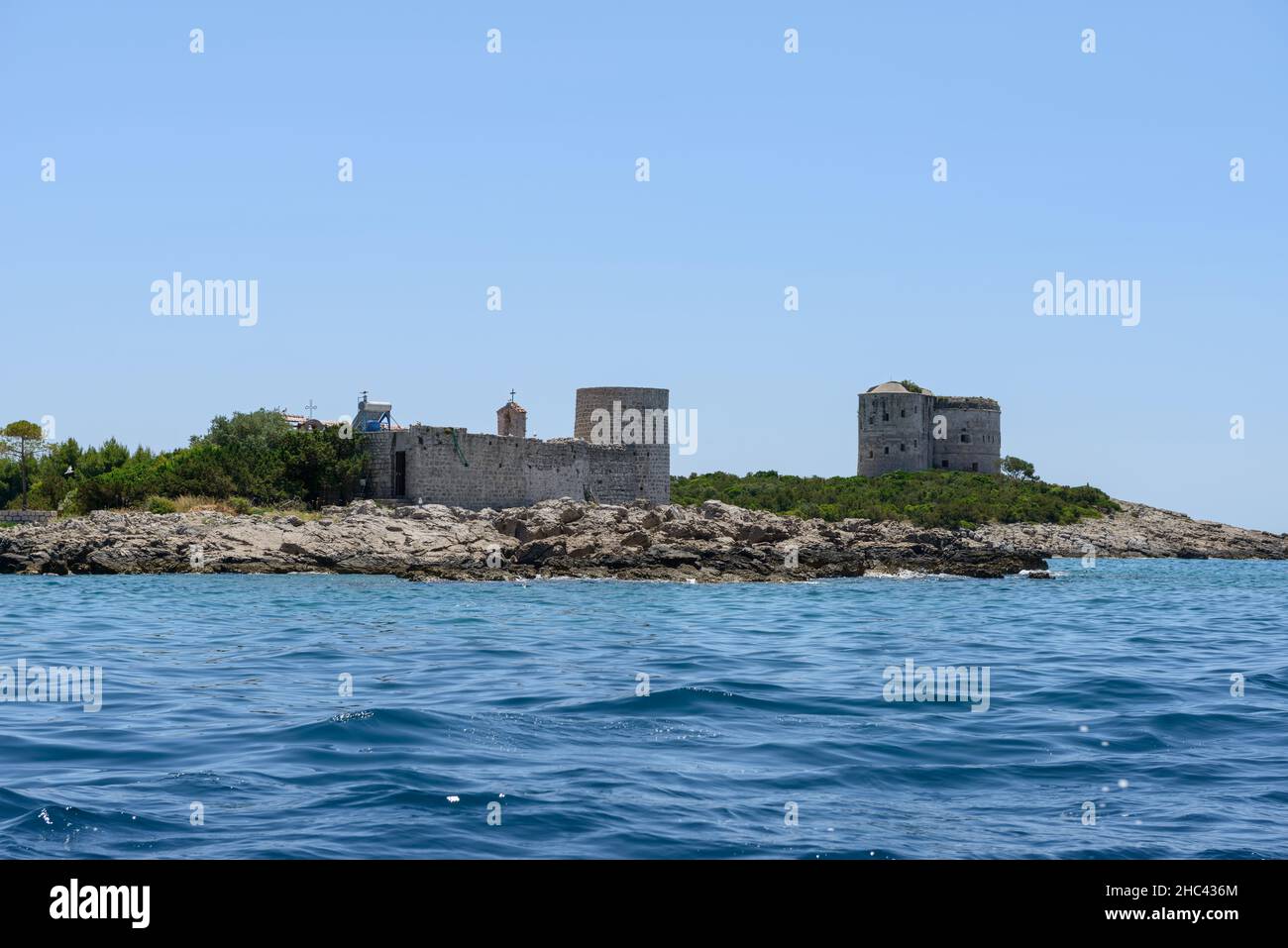 View from the sea bay towards small islet Gospa od Mirista and Arza fortress behind it near Žanjic, Montenegro. Stock Photo