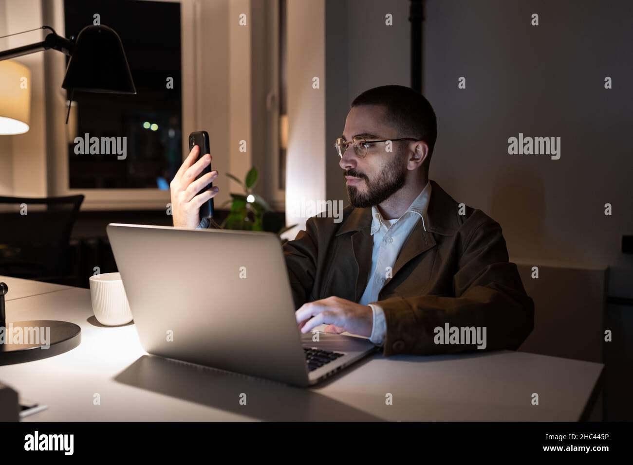 Busy front end developer or qa engineer testing app on smartphone work