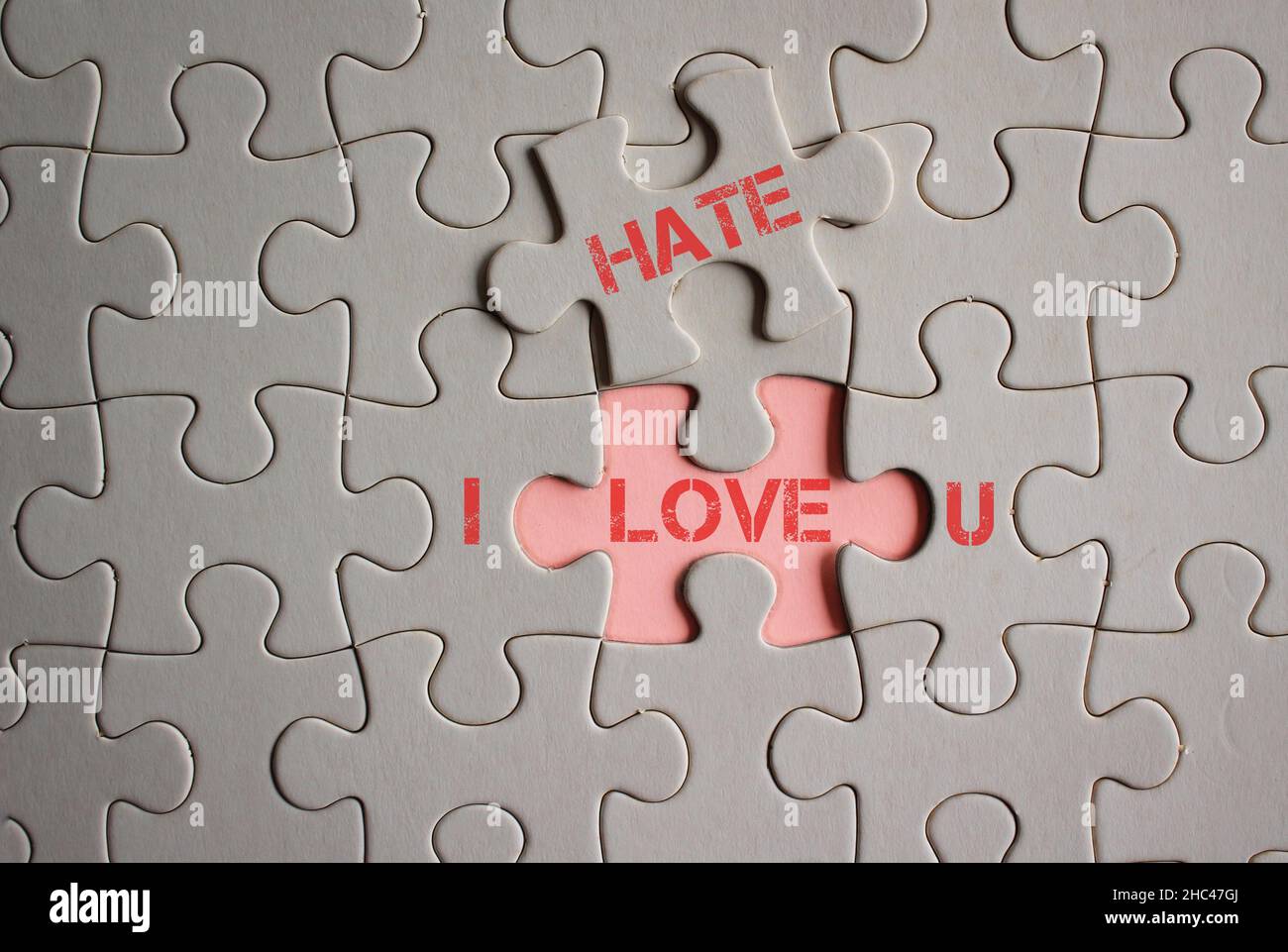 Concept of love hate relationship. I LOVE HATE U words written on pieces of jigsaw puzzle. Stock Photo