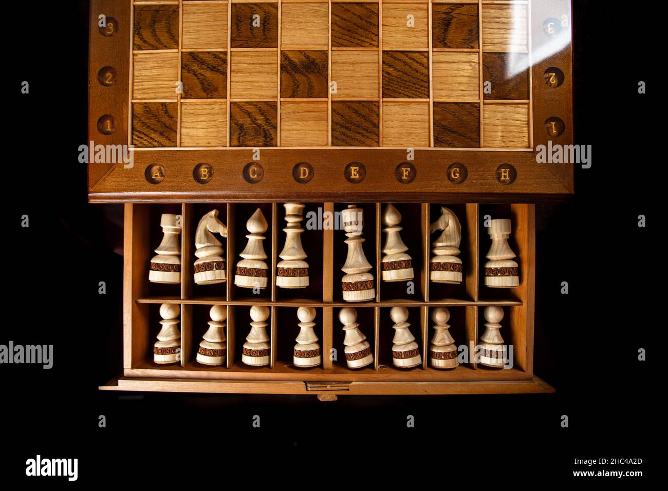 White chess pieces are stacked in a box. A puzzle game with tricky