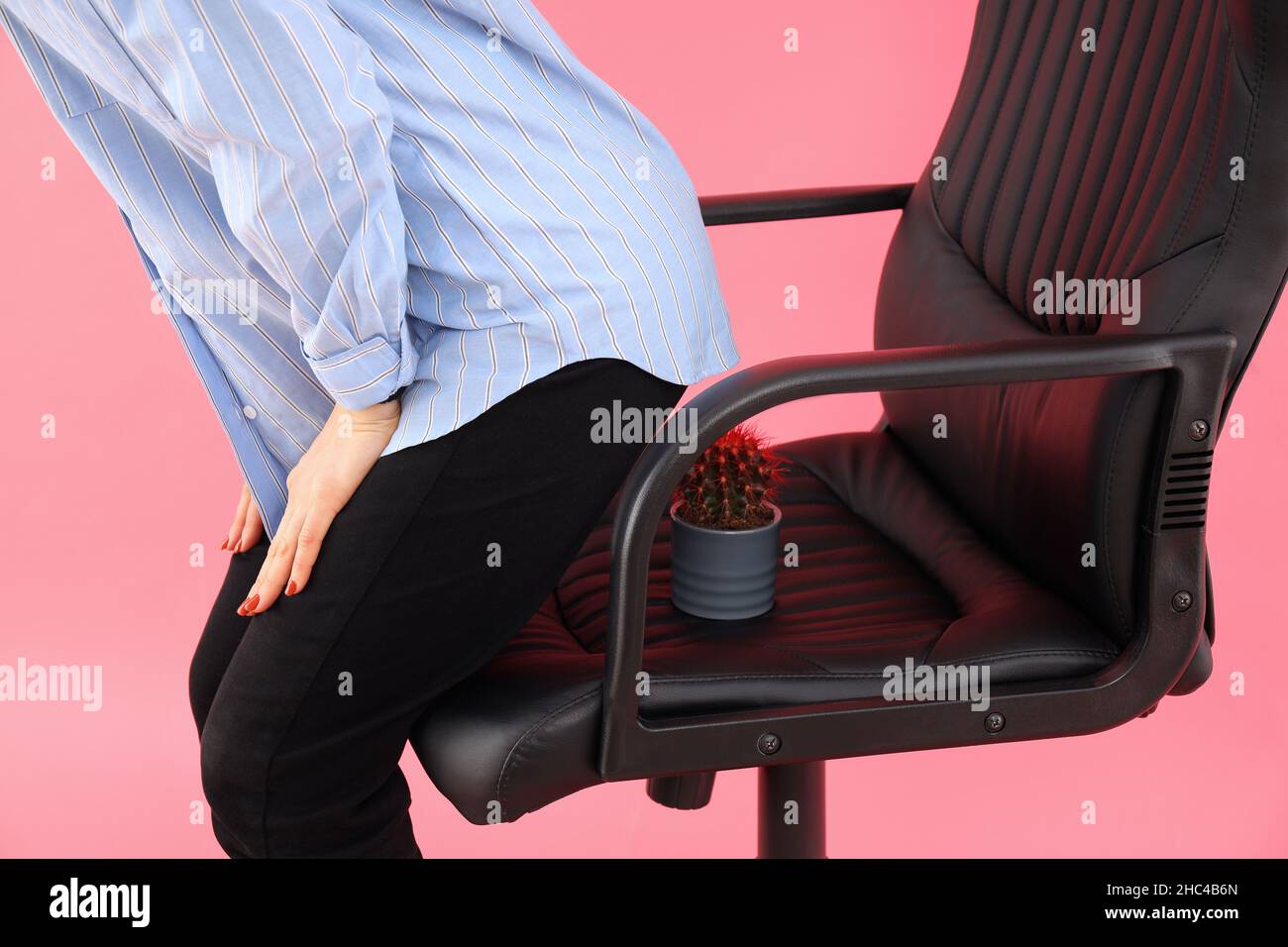 Woman sit down on a chair with a cactus on a pink background