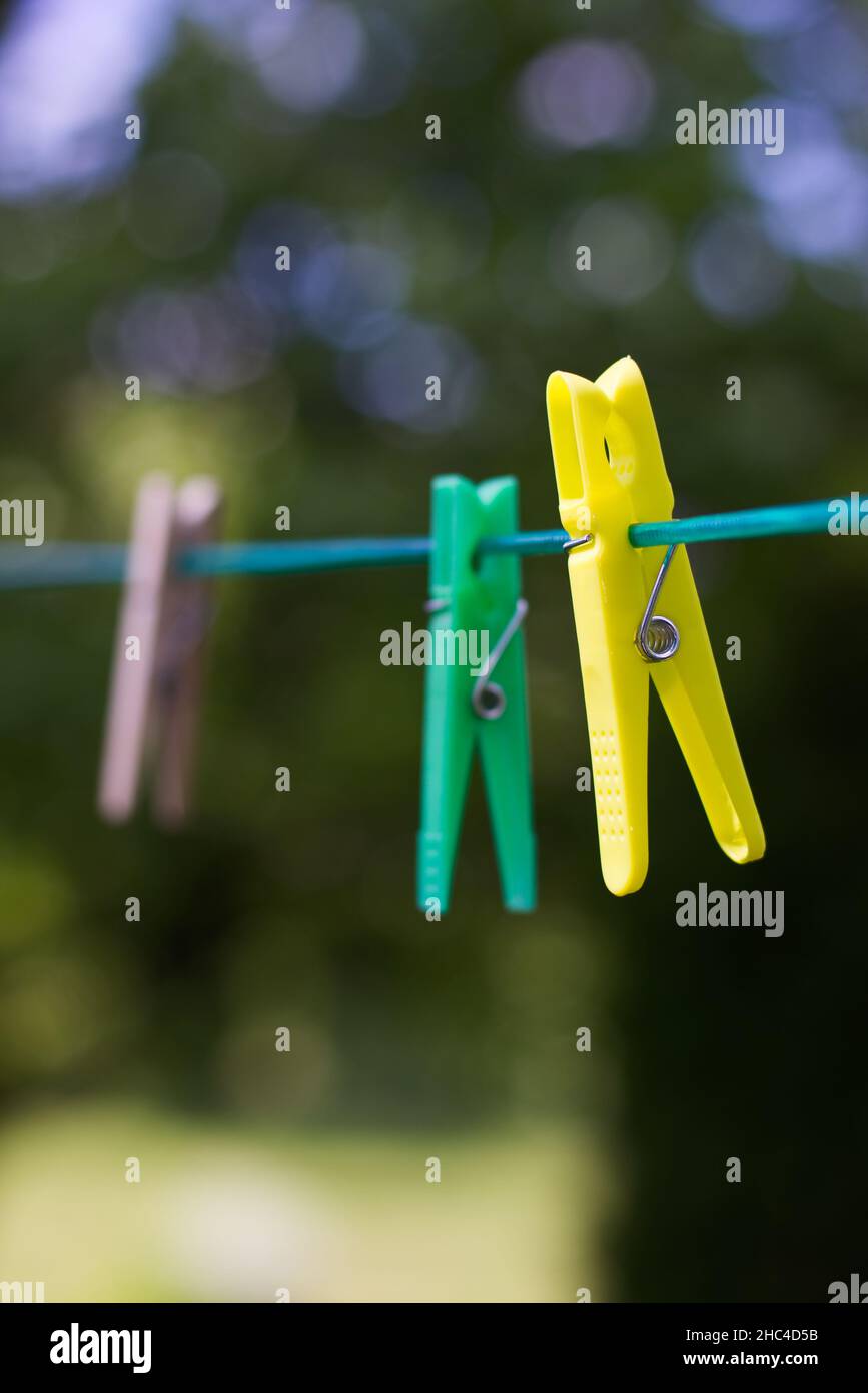 Colored plastic and wooden clothes pegs on the clothesline. Clothes