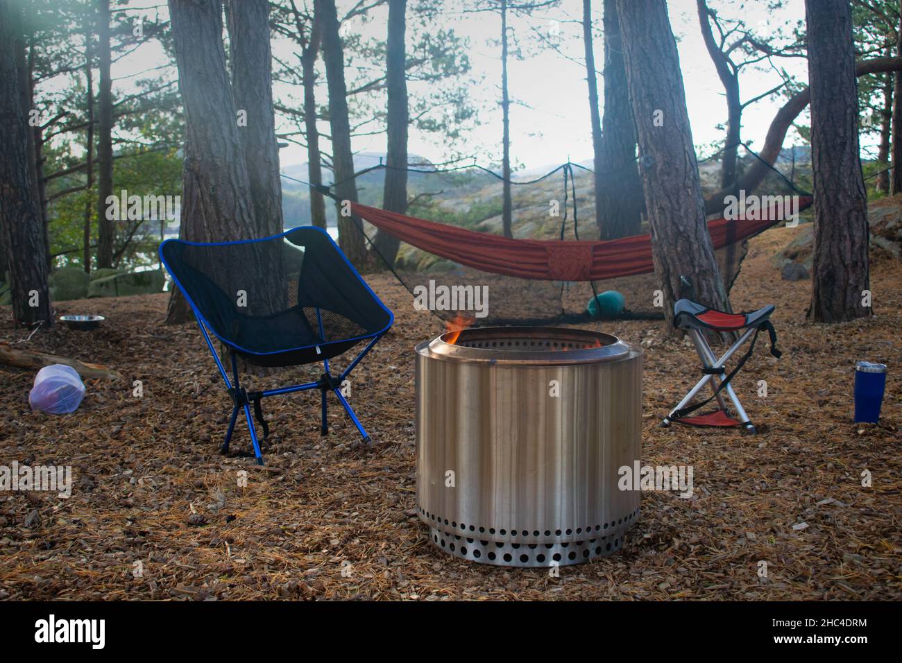 Forest Campsite with Fire Pit, Camp Chairs, and Hammock in Stavanger