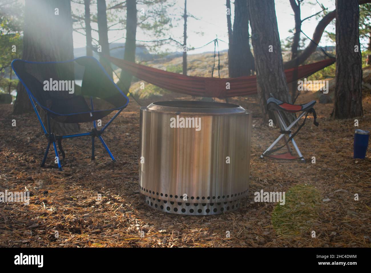 Forest Campsite with Fire Pit, Camp Chairs, and Hammock in Stavanger