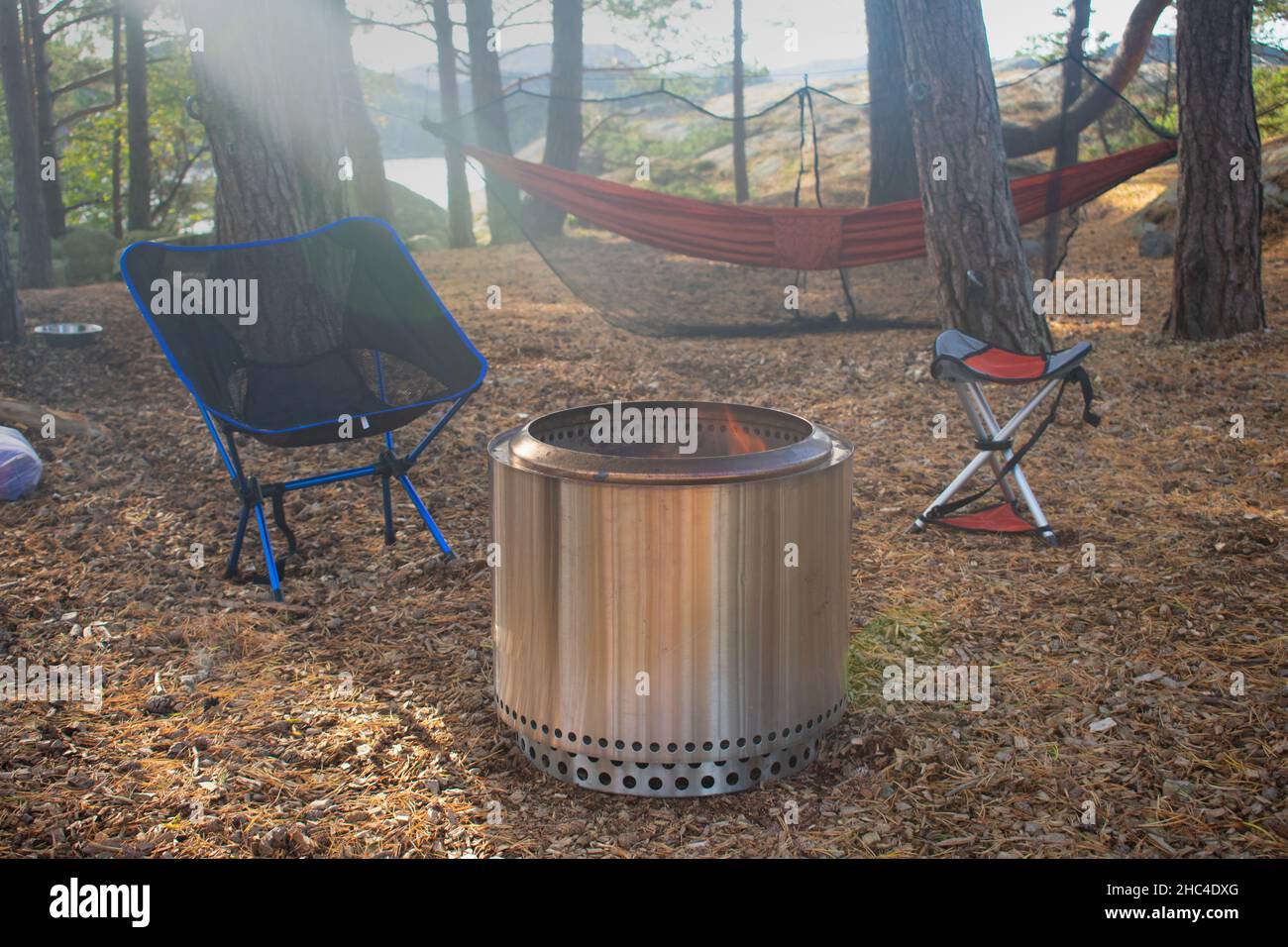 Forest Campsite with Fire Pit, Camp Chairs, and Hammock in Stavanger